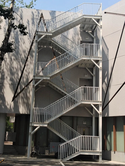 Black Rothnow outdoor staircase with sturdy metal steps and handrails, designed for fire escape and outdoor safety.