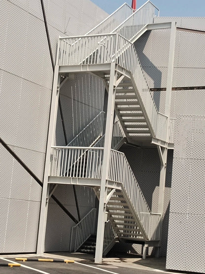 Black Rothnow outdoor staircase with fire escape design, featuring sturdy metal steps and handrails for emergency access.