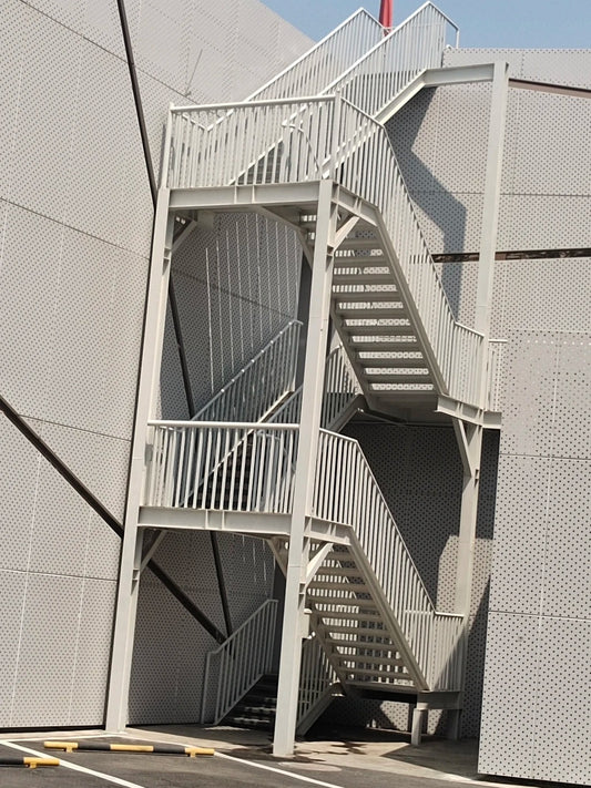 Black Rothnow outdoor staircase with fire escape design, featuring sturdy metal steps and handrails for emergency access.