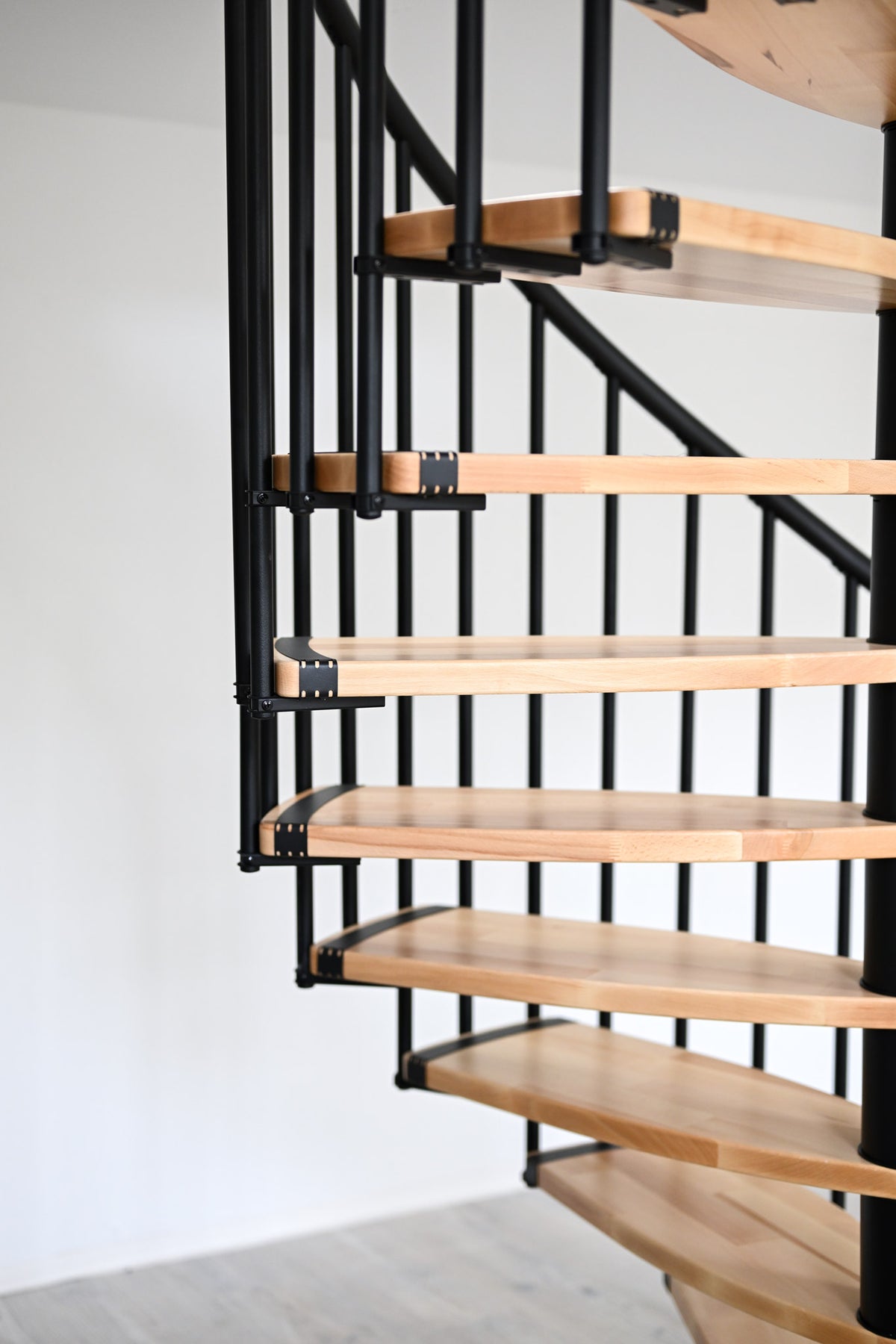 Black Rothnow spiral staircase RNSS04 wood model with customized size, showcasing sleek design and sturdy construction.