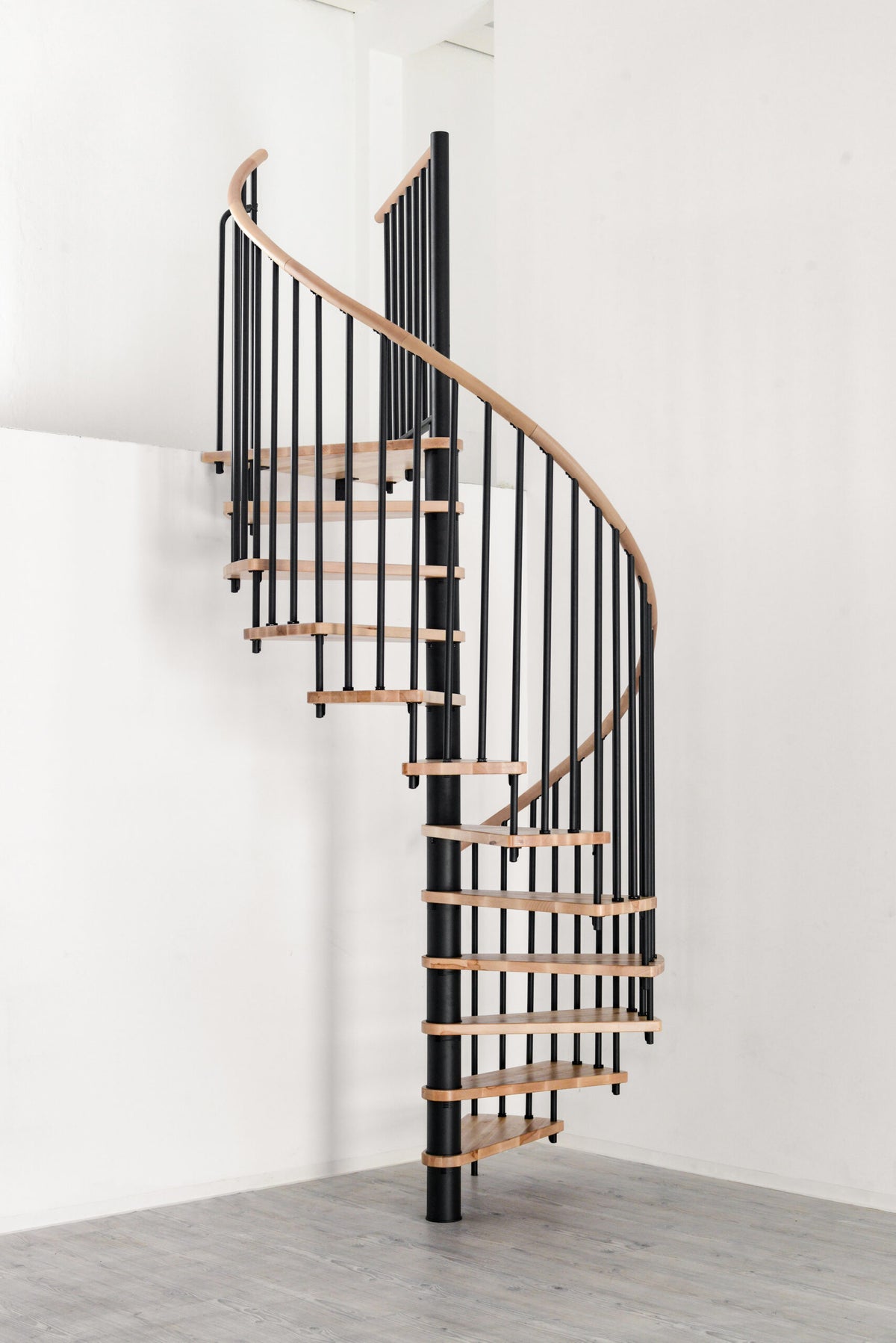 Rothnow® Wood Spiral Staircase RNSS04 with black finish, custom size, showcasing elegant curved design and wooden steps.