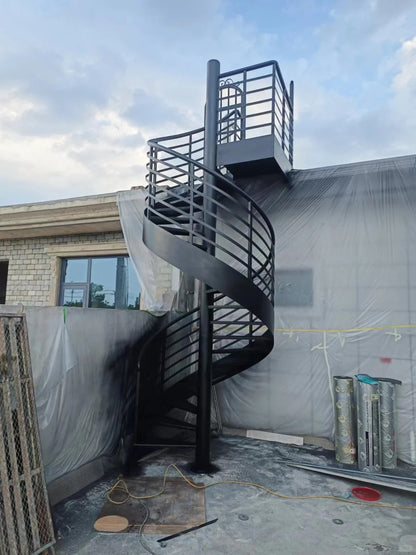 Rothnow outdoor carbon steel spiral staircase with black finish, custom-sized, featuring curved steps and railing for exterior use.