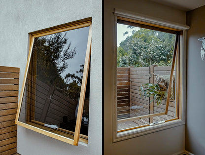 Rothnow® Wooden Awning Window RNWW04, black finish, with clear glass and wooden frame, installed in a modern home.
