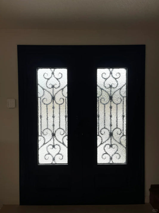 Wrought iron entrance door by Rothnow in black, featuring intricate ironwork design for a stylish entryway.
