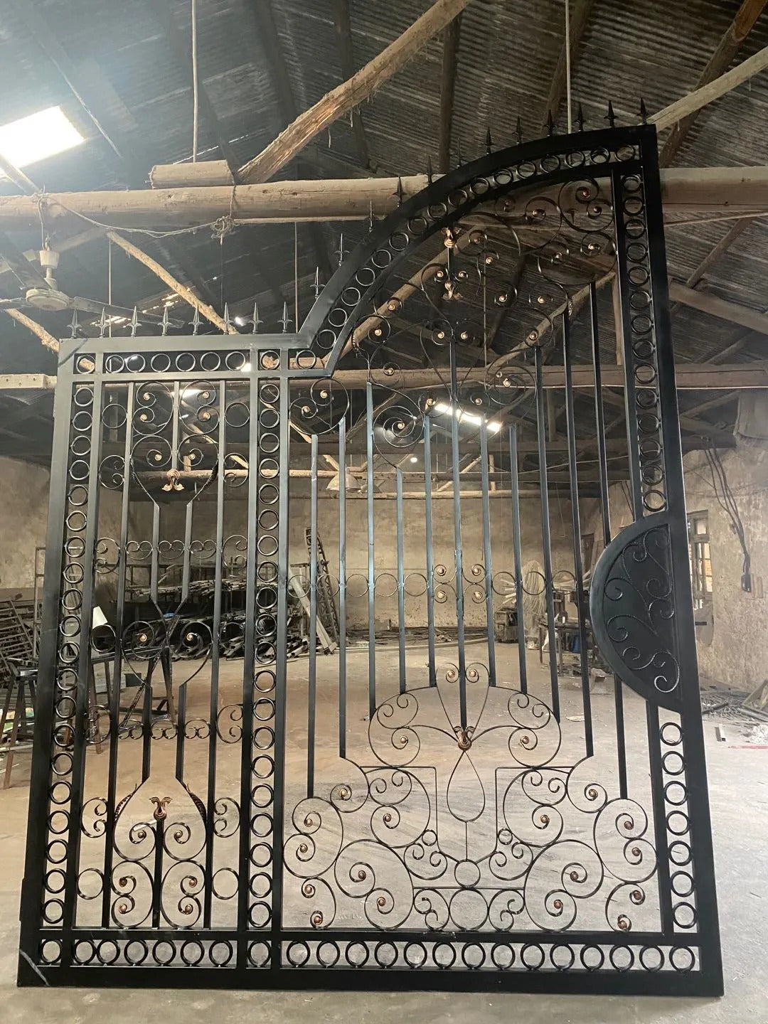 Black Rothnow wrought iron garden gate with decorative scrollwork and sturdy frame, custom-sized for outdoor fencing.