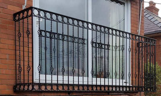 Black Rothnow wrought iron railing with decorative vertical bars and horizontal top rail, suitable for fences and outdoor safety.
