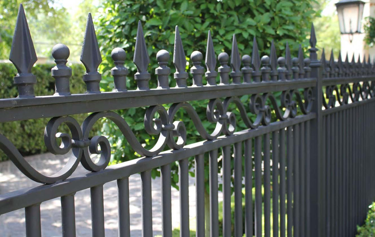 Rothnow wrought iron fence with decorative black railing, custom-sized for outdoor security and aesthetic appeal.