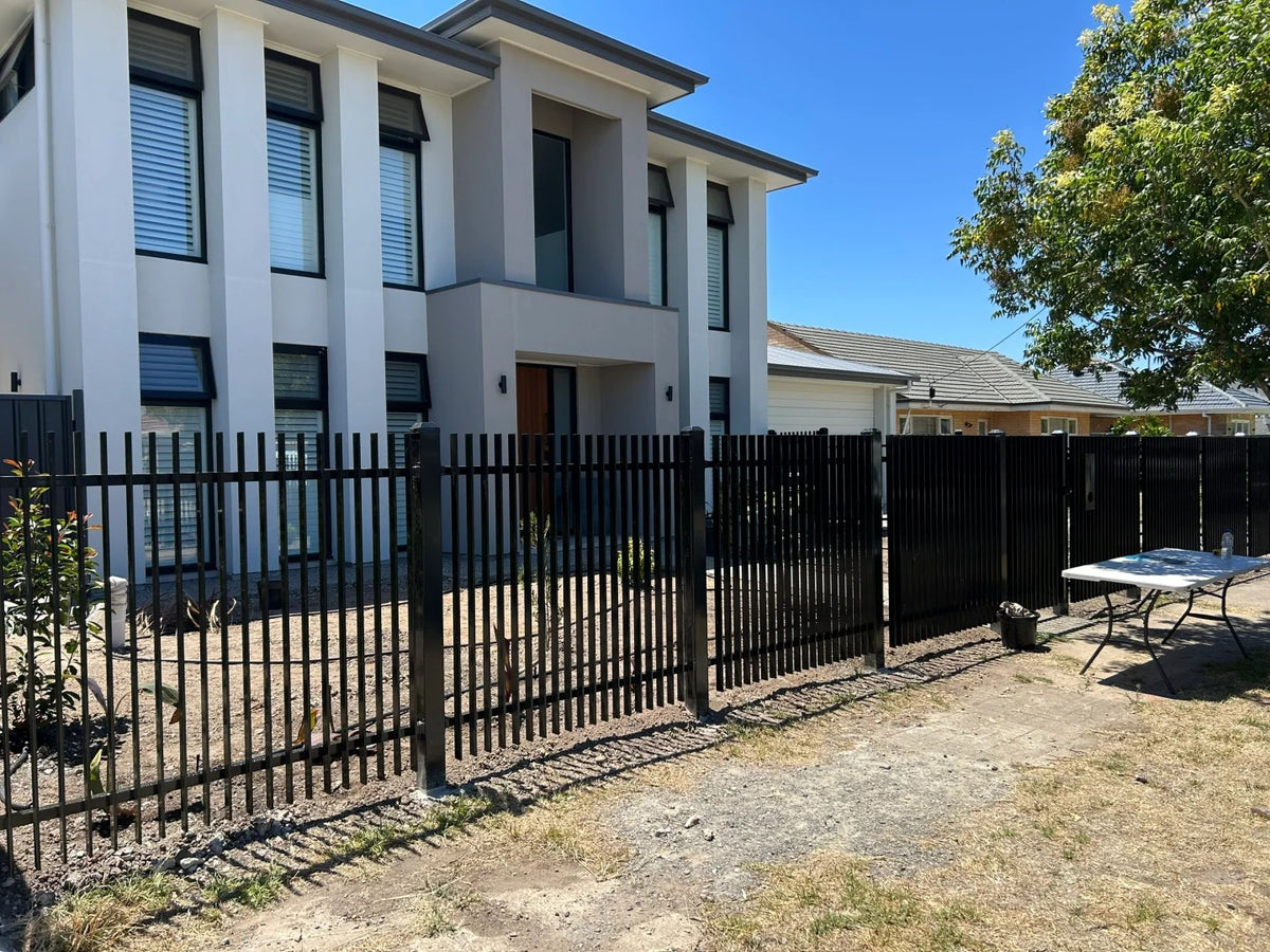 Black Rothnow wrought iron railing and fence with decorative design, custom-sized for outdoor safety and aesthetic enhancement.