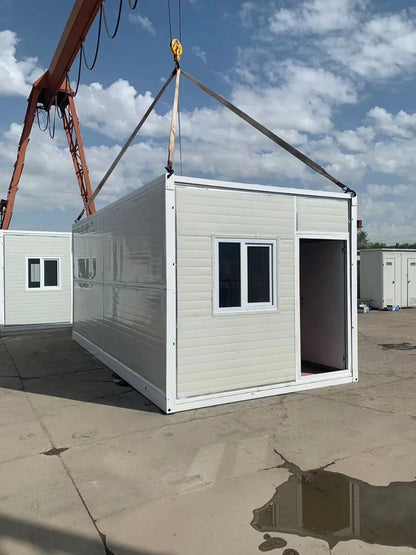 Black Rothnow® prefab foldable house made of steel structure, compact and modern design, shown in a spacious outdoor setting.