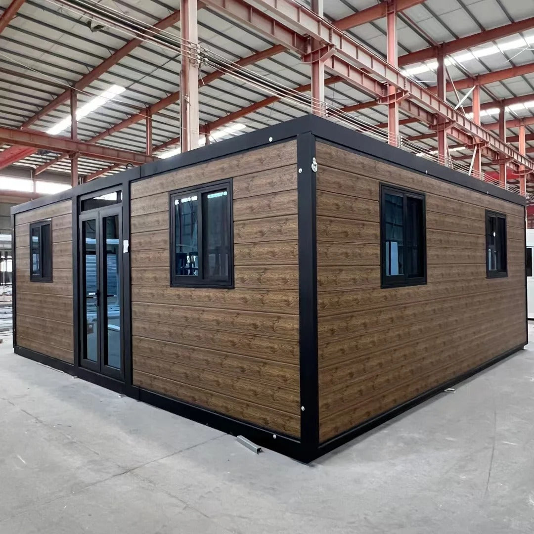 Black Rothnow Prefab House RNPH07 expandable steel structure building, shown in a spacious outdoor setting.