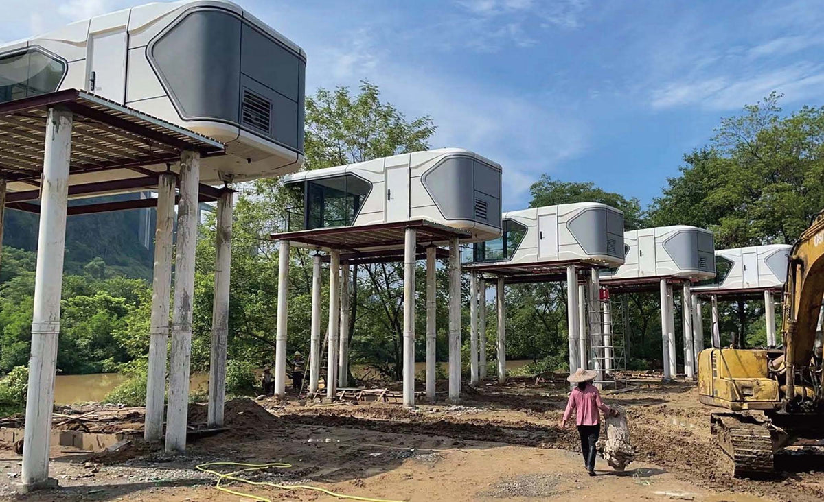 Rothnow Space Capsule House RNSH02-V5 in black, steel structure building with sleek, modern design and large windows.